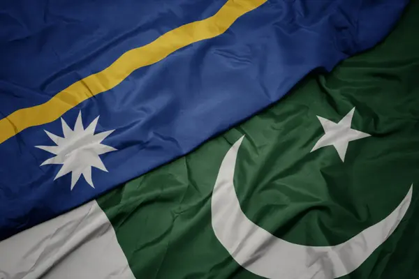 Waving colorful flag of pakistan and national flag of Nauru ,. — Stock Photo, Image