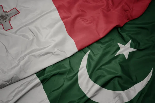 Waving colorful flag of pakistan and national flag of malta. — Stock Photo, Image