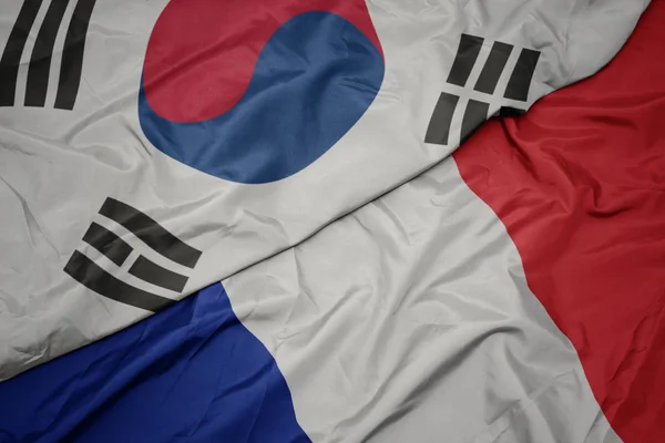 Ondeando colorida bandera de Francia y bandera nacional de Corea del Sur . — Foto de Stock