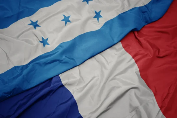 Macha kolorowy flaga Francji i flagi narodowej Hondurasu. — Zdjęcie stockowe