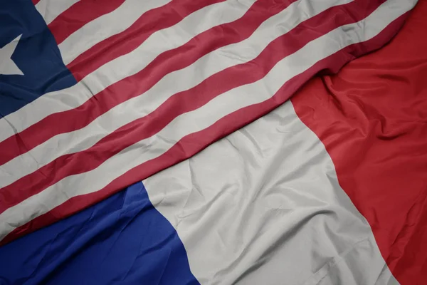 Fransa ve liberya ulusal bayrağı renkli bayrak sallayarak. — Stok fotoğraf