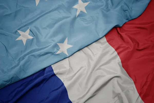 Waving colorful flag of france and national flag of Federated States of Micronesia ,. — Stock Photo, Image