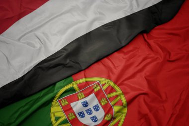 portekiz ve yemen ulusal bayrağı renkli bayrak sallayarak