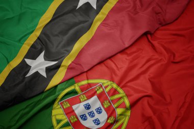 portekiz renkli bayrak ve aziz kitts ve nevis ulusal bayrak sallayarak.