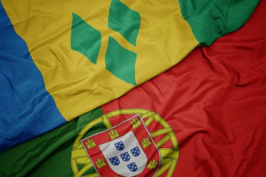 portekiz ve aziz vincent ve grenadinler ulusal bayrağı renkli bayrak sallayarak.