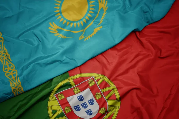 ポルトガルのカラフルな旗とカザフスタンの国旗を振る. — ストック写真