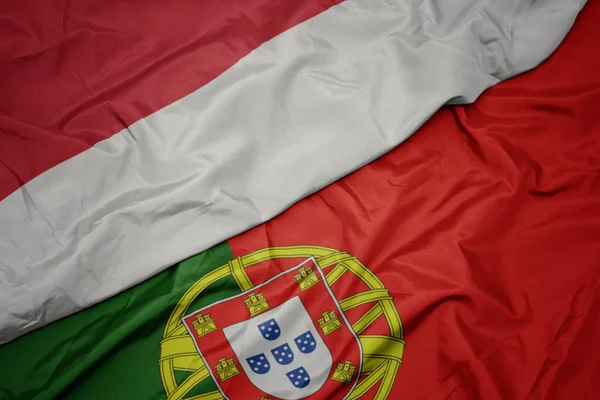 portekiz ve endonezya ulusal bayrağı renkli bayrak sallayarak.