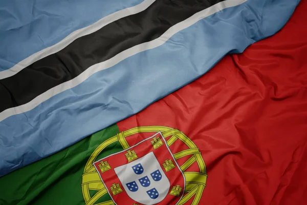 portekiz ve botsvana ulusal bayrak renkli bayrak sallayarak.