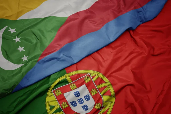 ポルトガルのカラフルな旗とコモロの国旗を振る. — ストック写真