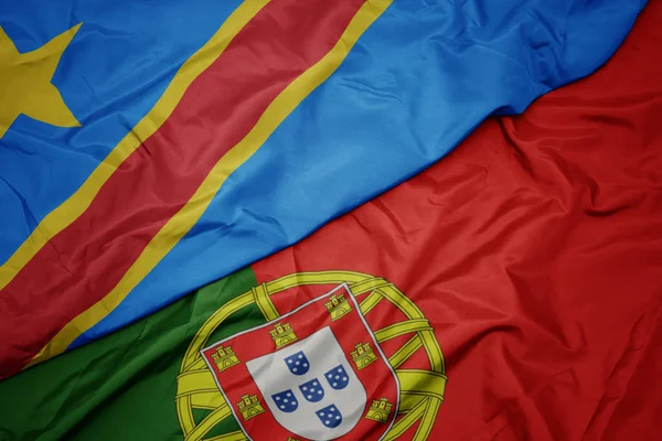 Acenando bandeira colorida de portugal e bandeira nacional da república democrática do congo . — Fotografia de Stock