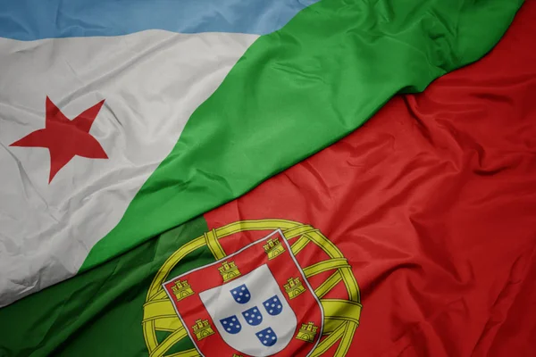 portekiz renkli bayrak ve cibuti ulusal bayrağı sallayarak.