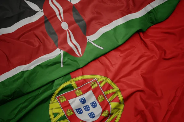 Sventolando bandiera colorata del Portogallo e bandiera nazionale del Kenya . — Foto Stock
