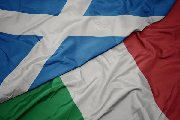 Ondeando colorida bandera de italia y bandera nacional de Escocia . —  Fotos de Stock
