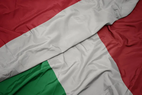 Waving colorful flag of italy and national flag of indonesia. — Stock Photo, Image