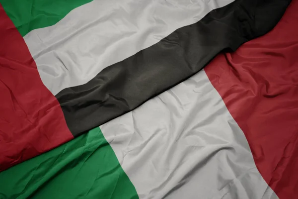 Waving colorful flag of italy and national flag of united arab emirates. — Stock Photo, Image