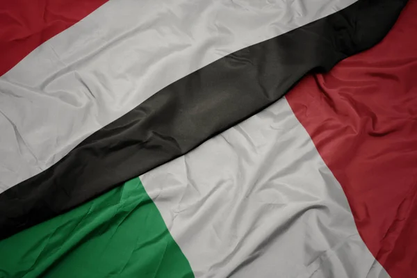 Waving colorful flag of italy and national flag of yemen. — Stock Photo, Image