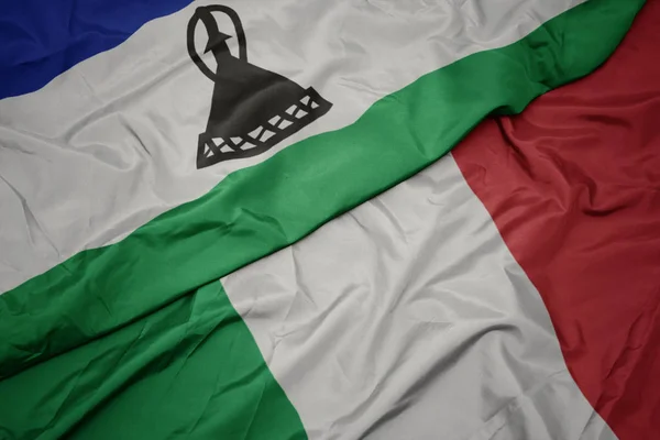 Waving colorful flag of italy and national flag of lesotho. — Stock Photo, Image