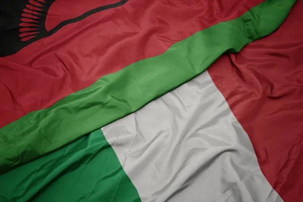Waving colorful flag of italy and national flag of malawi. — Stock Photo, Image