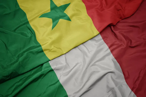 Waving colorful flag of italy and national flag of senegal. — Stock Photo, Image