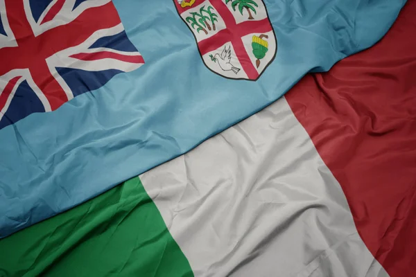 Waving colorful flag of italy and national flag of Fiji ,. — Stock Photo, Image