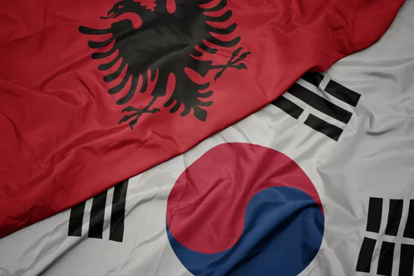 Sventolando bandiera colorata della Corea del Sud e bandiera nazionale di albania . — Foto Stock