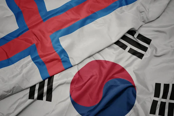 Waving colorful flag of south korea and national flag of faroe islands. — Stock Photo, Image