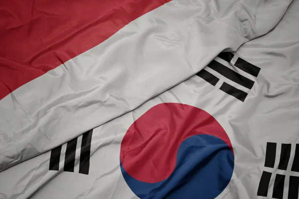 Ondeando colorida bandera de Corea del Sur y bandera nacional de indonesia . — Foto de Stock