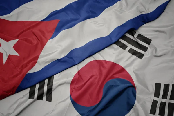 Falujące kolorowe flagi Korei Południowej i flagi narodowej Kuby. — Zdjęcie stockowe