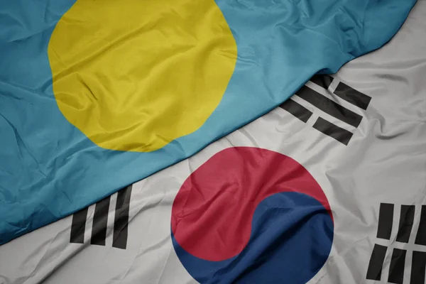 Ondeando colorida bandera de Corea del Sur y bandera nacional de Palaos  ,. — Foto de Stock