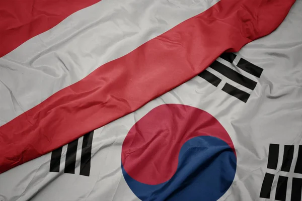 Ondeando colorida bandera de Corea del Sur y bandera nacional de austria . — Foto de Stock