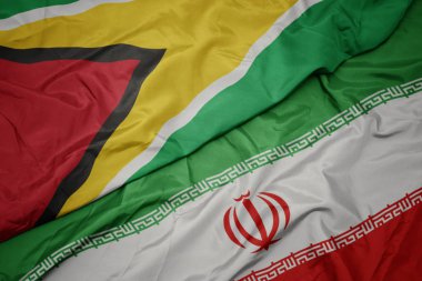 İran ve guyana ulusal bayrağı renkli bayrak sallayarak.