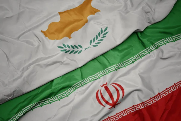 Waving colorful flag of iran and national flag of cyprus. — Stock Photo, Image