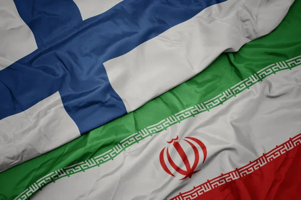 Waving colorful flag of iran and national flag of finland. — Stock Photo, Image