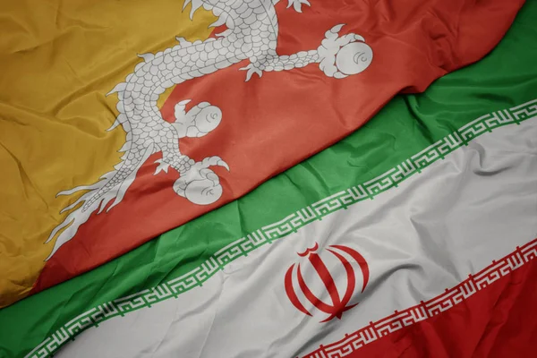 Ondeando colorida bandera de Irán y bandera nacional de Bután . —  Fotos de Stock