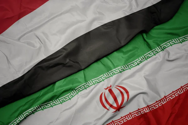 Waving colorful flag of iran and national flag of yemen. — Stock Photo, Image