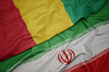 İran ve gine ulusal bayrağı renkli bayrak sallayarak.