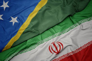 İran ve Solomon Adaları ulusal bayrağı renkli bayrak sallayarak .