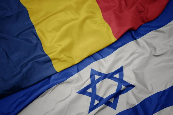 Waving colorful flag of israel and national flag of romania. — Stock Photo, Image