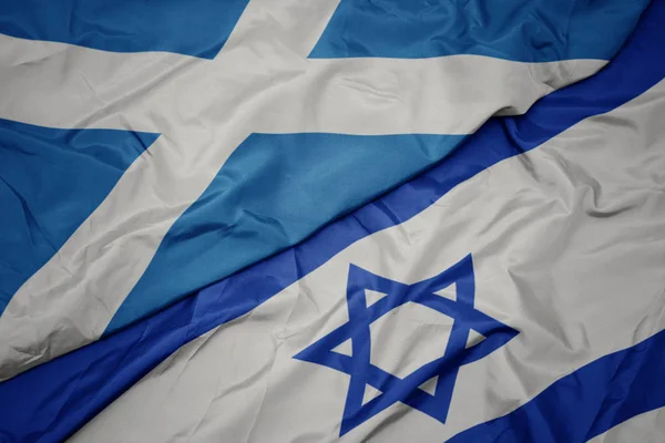 Ondeando colorida bandera de Israel y bandera nacional de Escocia . —  Fotos de Stock