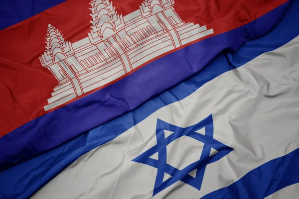 Ondeando colorida bandera de Israel y bandera nacional de Camboya . —  Fotos de Stock