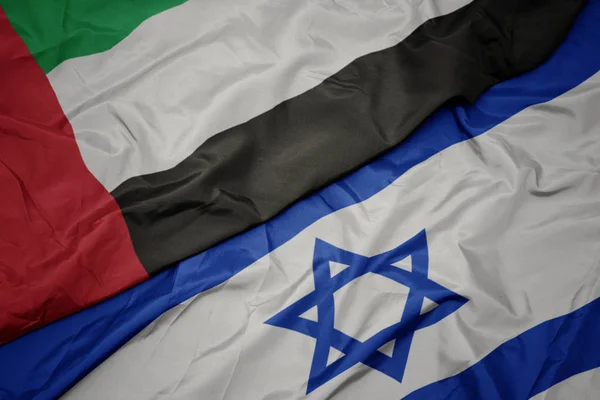 Waving colorful flag of israel and national flag of united arab emirates. — Stock Photo, Image