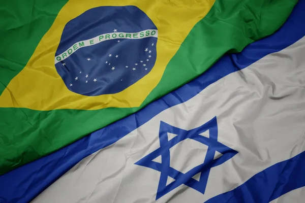 Waving colorful flag of israel and national flag of brazil. — Stock Photo, Image