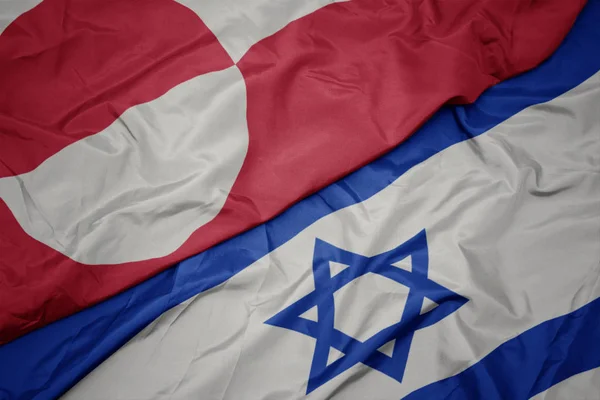 Waving colorful flag of israel and national flag of greenland. — Stock Photo, Image
