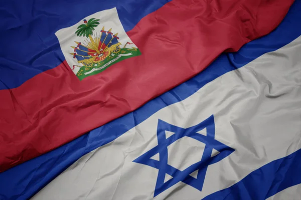 Ondeando colorida bandera de Israel y bandera nacional de Haití . —  Fotos de Stock