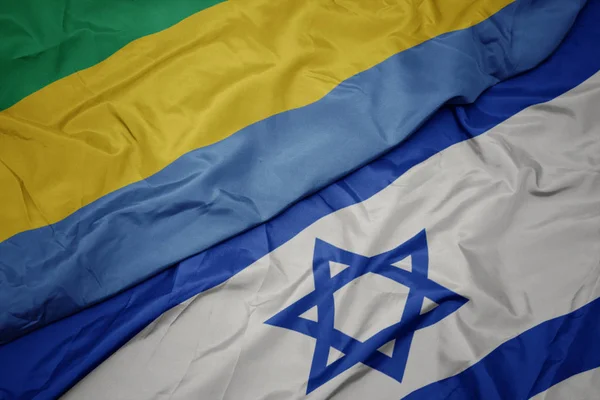 İsrail ve gabon ulusal bayrağı renkli bayrak sallayarak. — Stok fotoğraf