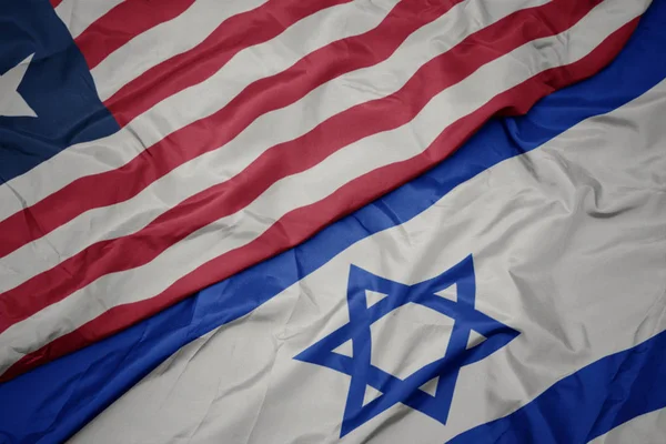 Ondeando colorida bandera de Israel y bandera nacional de Liberia . —  Fotos de Stock