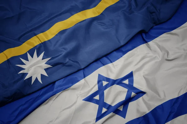 Ondeando colorida bandera de Israel y bandera nacional de Nauru  . —  Fotos de Stock