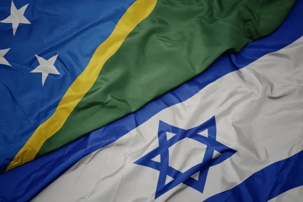 Ondeando colorida bandera de Israel y bandera nacional de las Islas Salomón  . —  Fotos de Stock