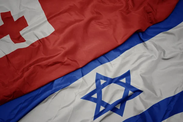 Ondeando colorida bandera de Israel y bandera nacional de Tonga  . —  Fotos de Stock