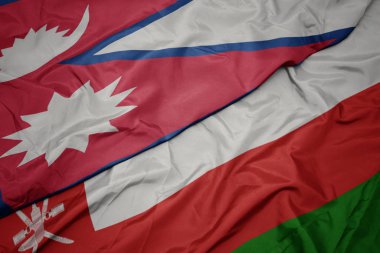 umman renkli bayrak ve nepal ulusal bayrak sallayarak.